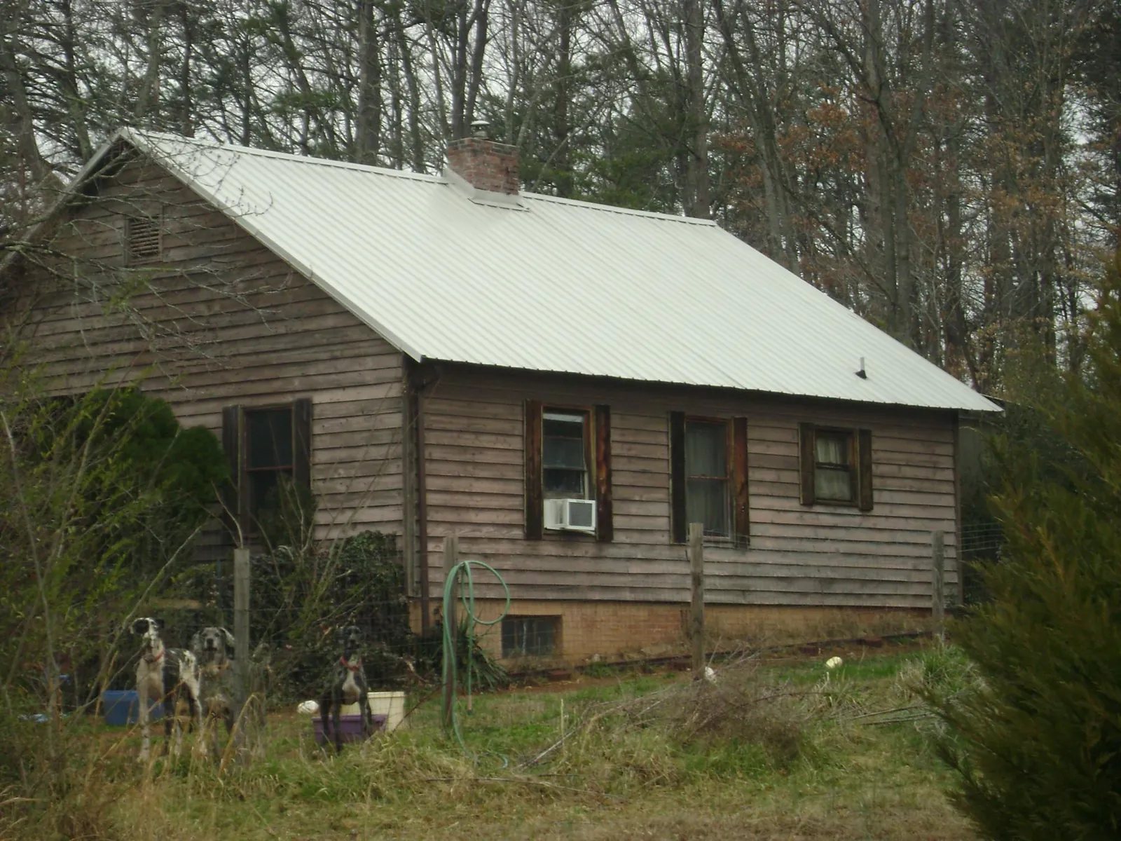 White metal roof on an old wood sided farmhouse, from a Metal Roof Installation job in Spring Hill